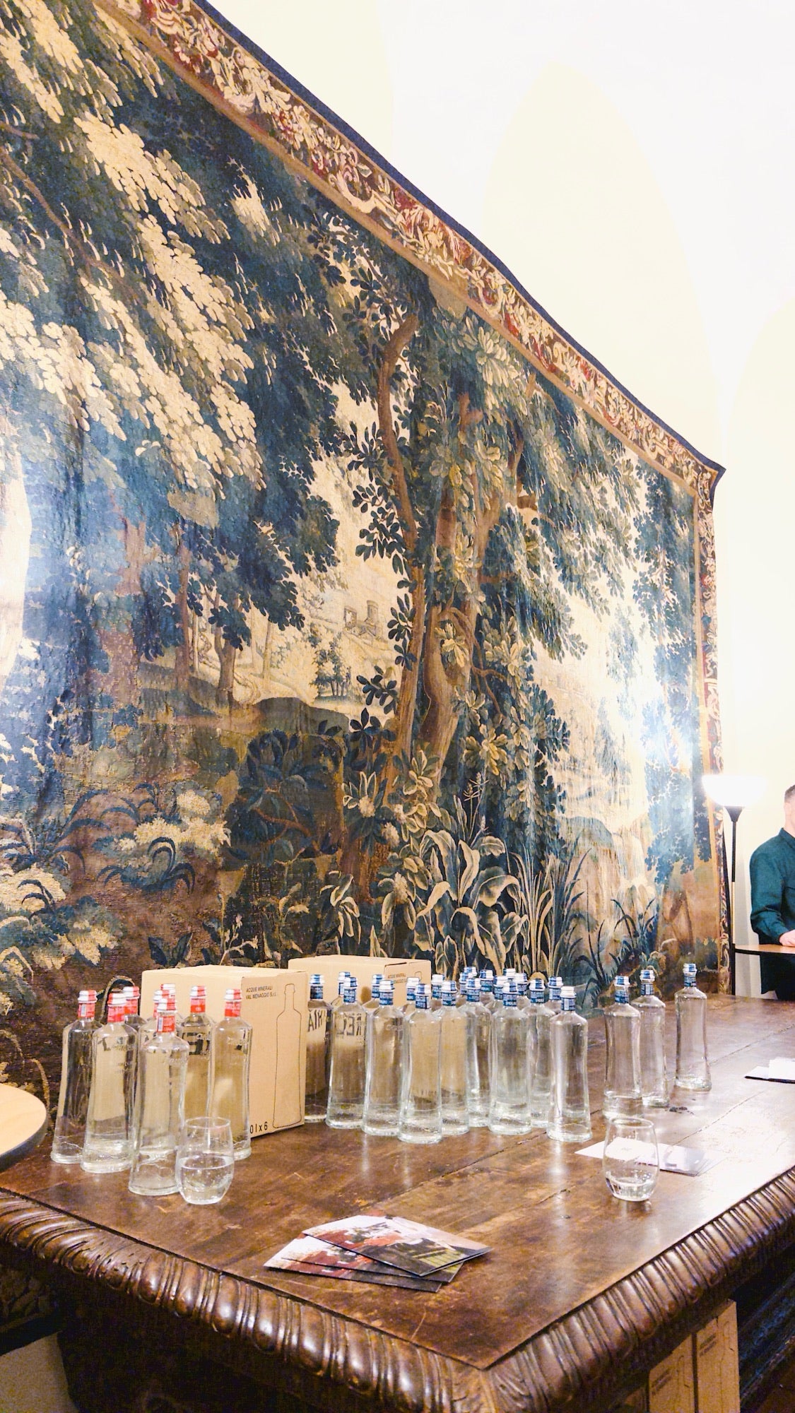 Bottles beneath a tapestry
